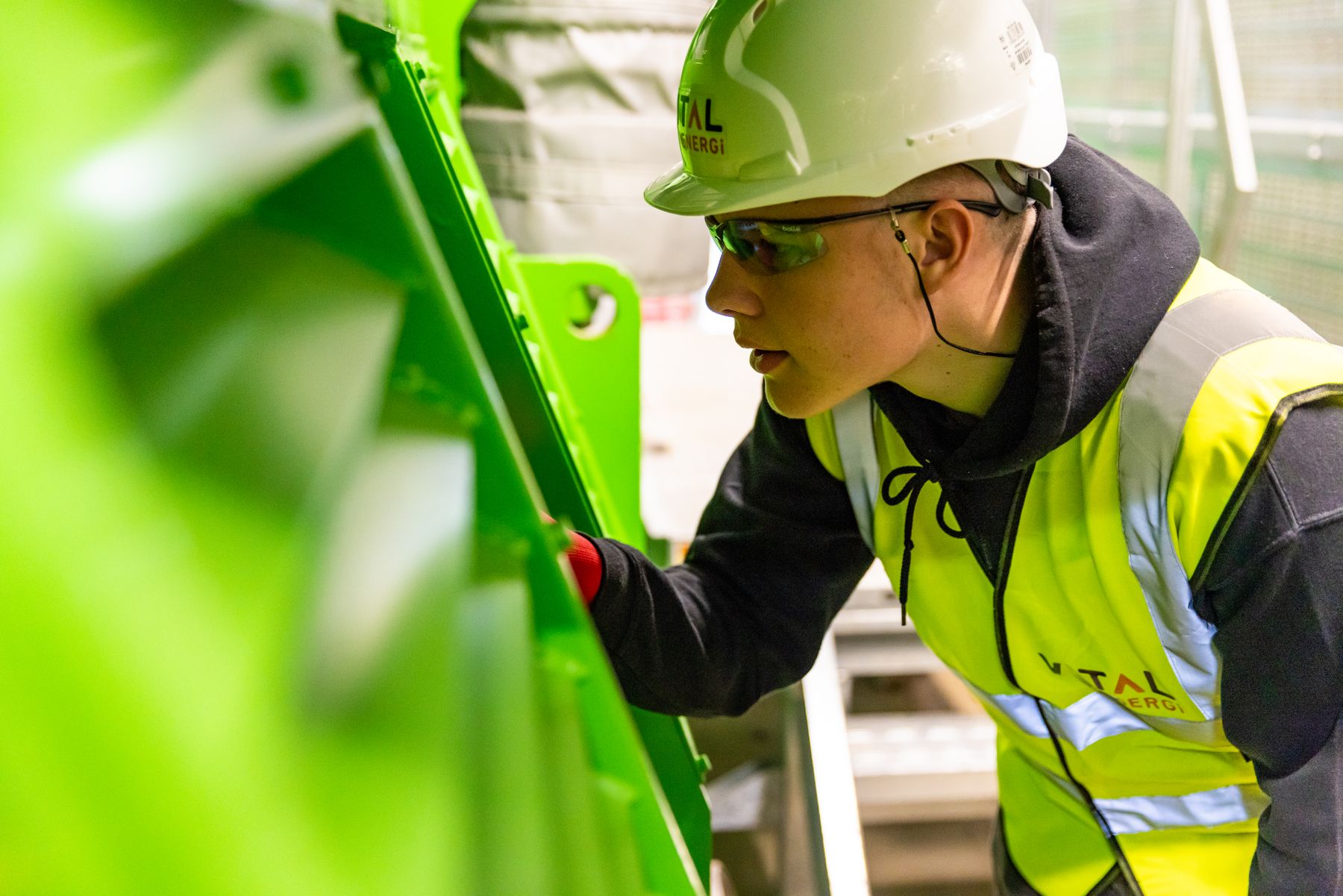 Industrial maintenance professional inspecting plant machinery as part of a lubrication program